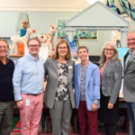 Group of business professionals standing together in a library